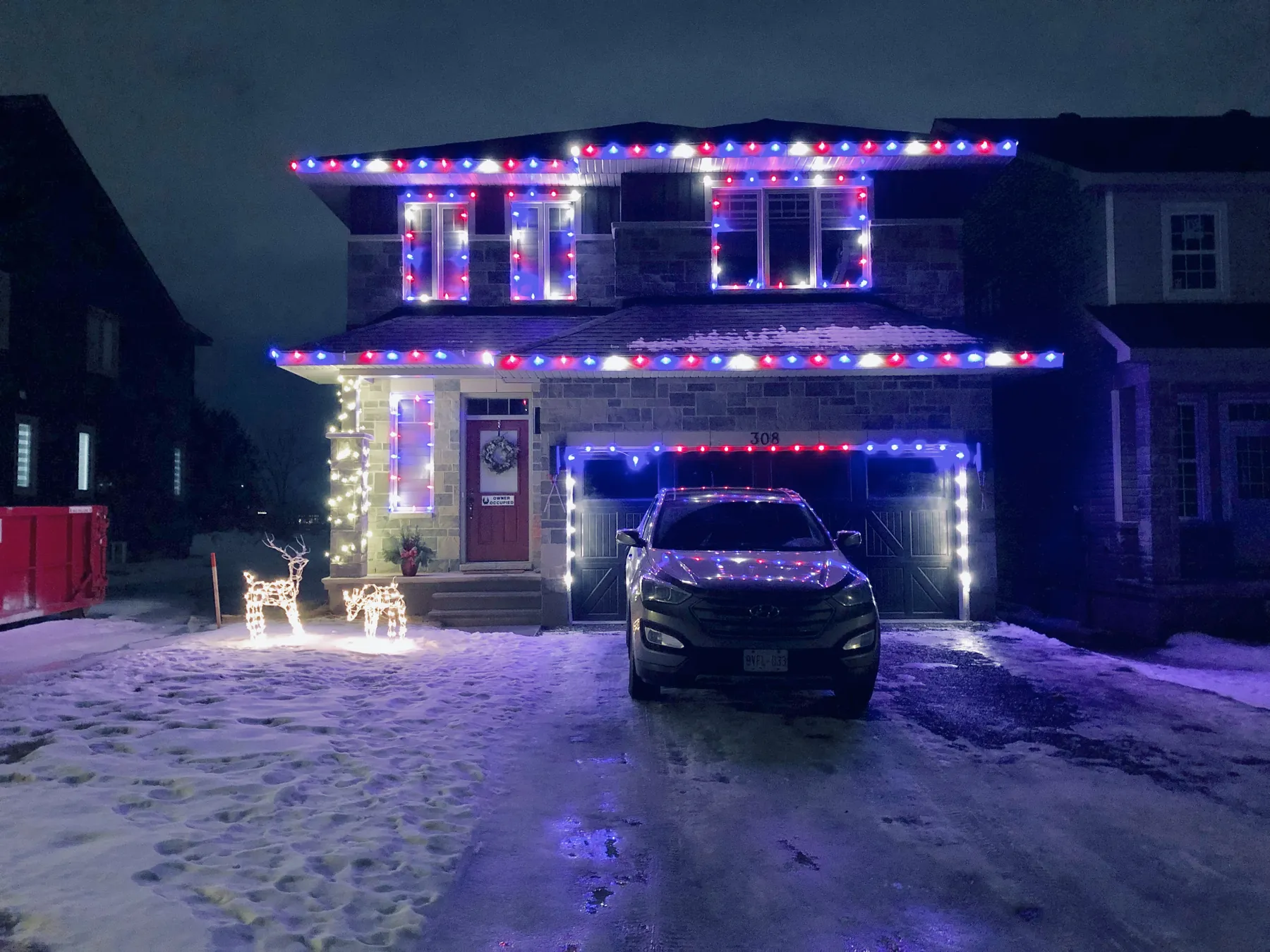 Home illuminated in colourful holiday lights