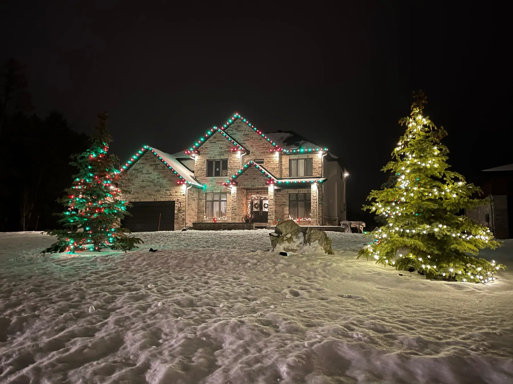 Red, green, and white lights across a property