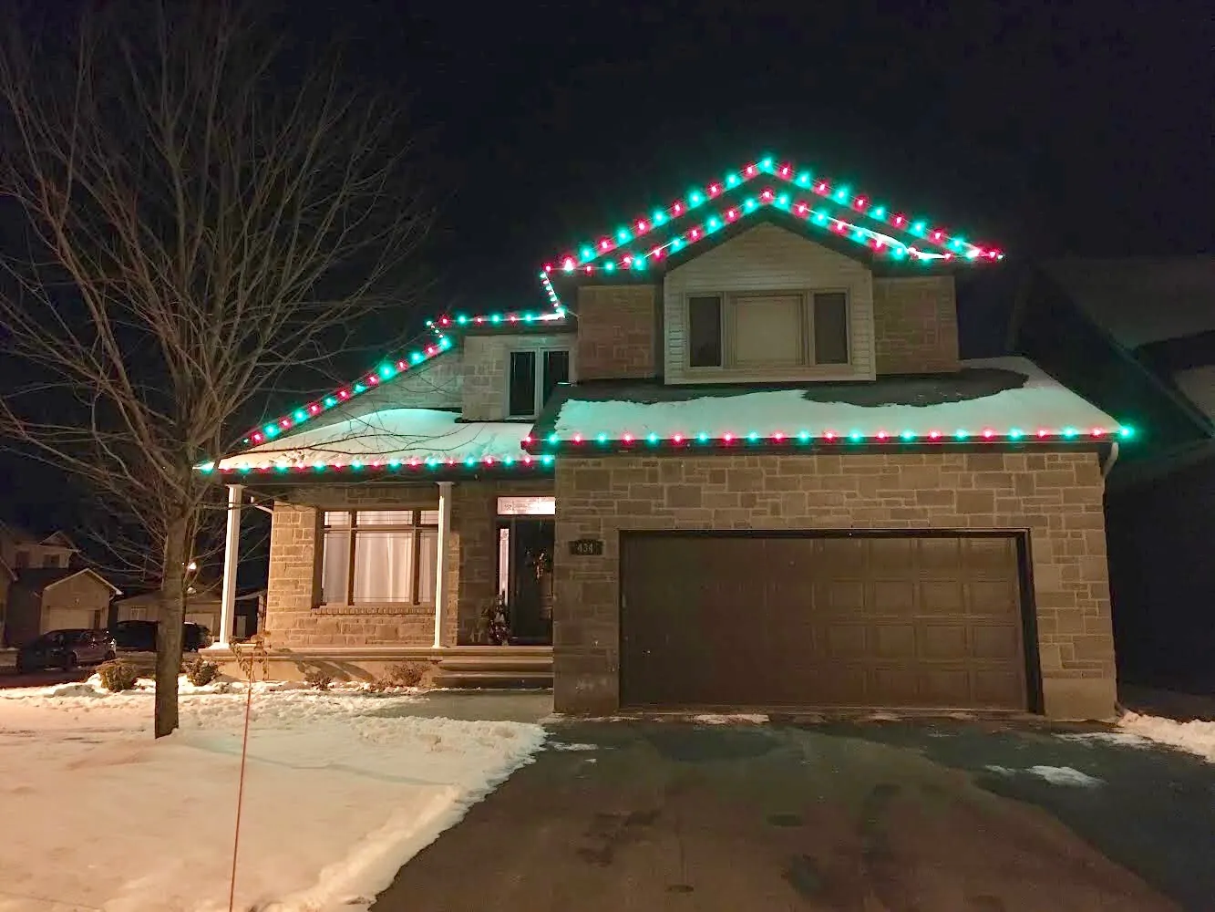Red and green bulbs tracing a roofline